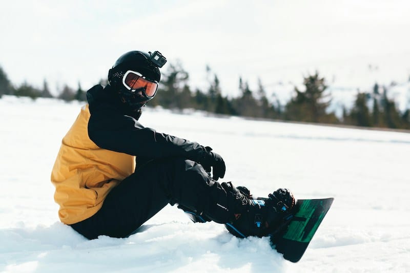 Sitting on snow in snowboard pants