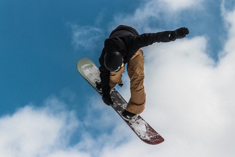 Freestyle snowboarding off a jump